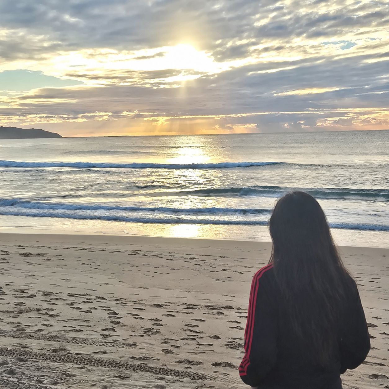 Amna, founder of She Builds From Here, looking out at the ocean